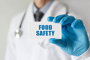 Doctor Holding a Card with Food Safety Text